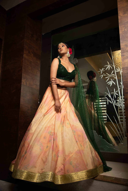 A LA MODE HERITAGE'S CORAL TISSUE LEHENGA WITH EMERALD SEQUENCE BLOUSE